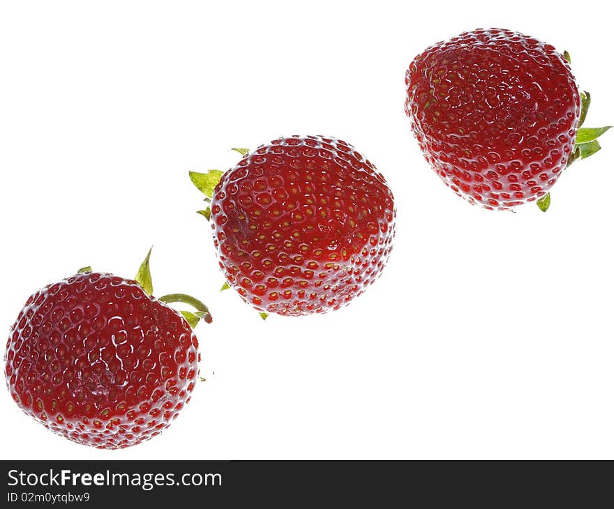 Three strawberries on white background