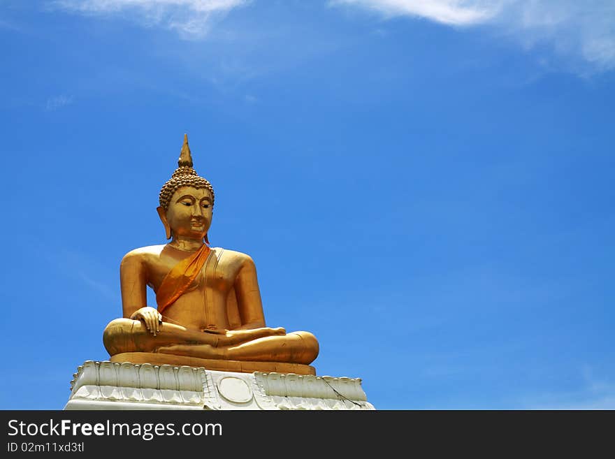 Old golden buddha with cracked texture in clear sky.Phetchaburi Thailand.