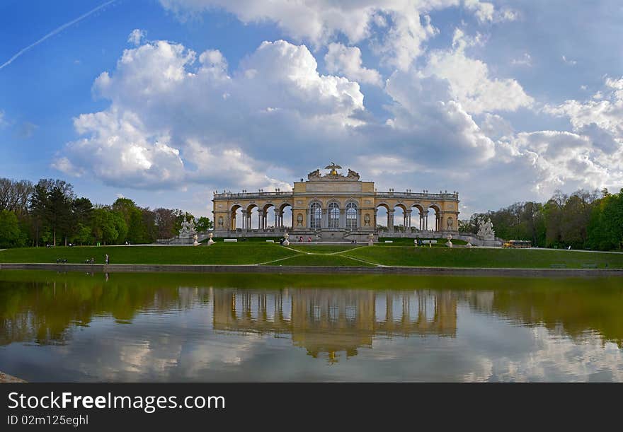 Schonbrunn, Pavilion Glorietta reflected in a pond at sunset, the sky clouds