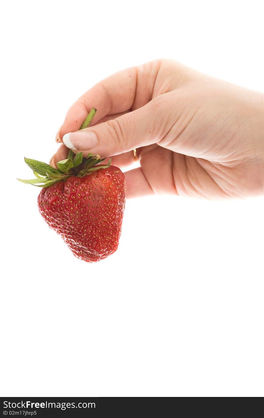 Young women testing large strawberry. Young women testing large strawberry