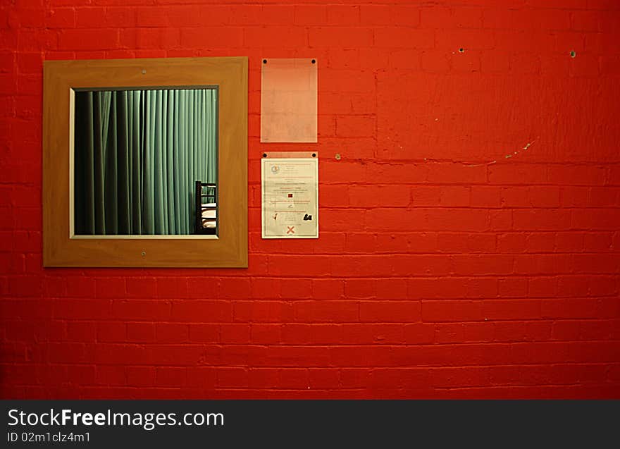 Wooden mirror on a red brick wall. Wooden mirror on a red brick wall