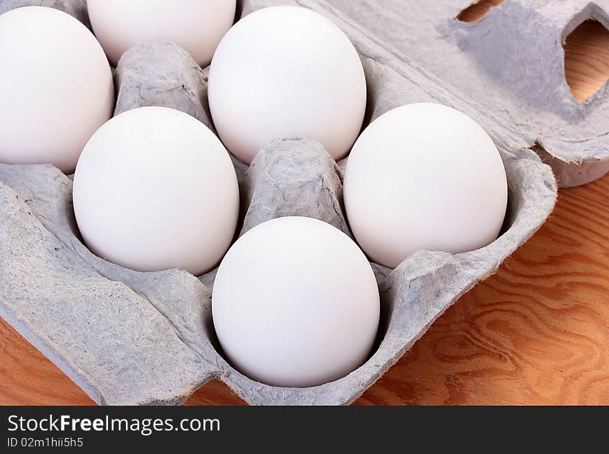 Eggs of white colour are combined in a special tray for transportation and sale.