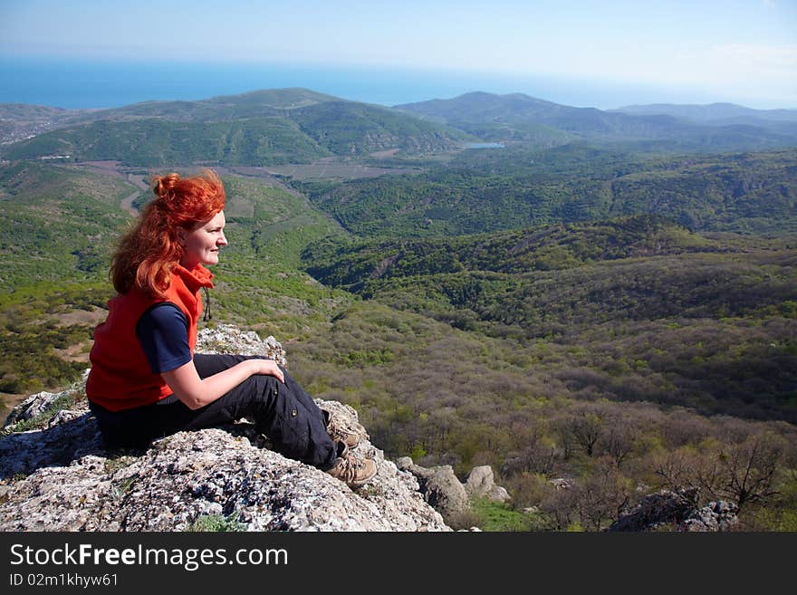 Woman sitting on a cliff