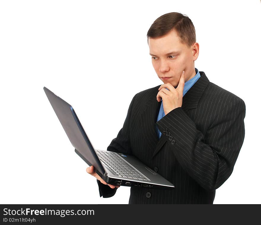 Businessman thinking over his laptop computer