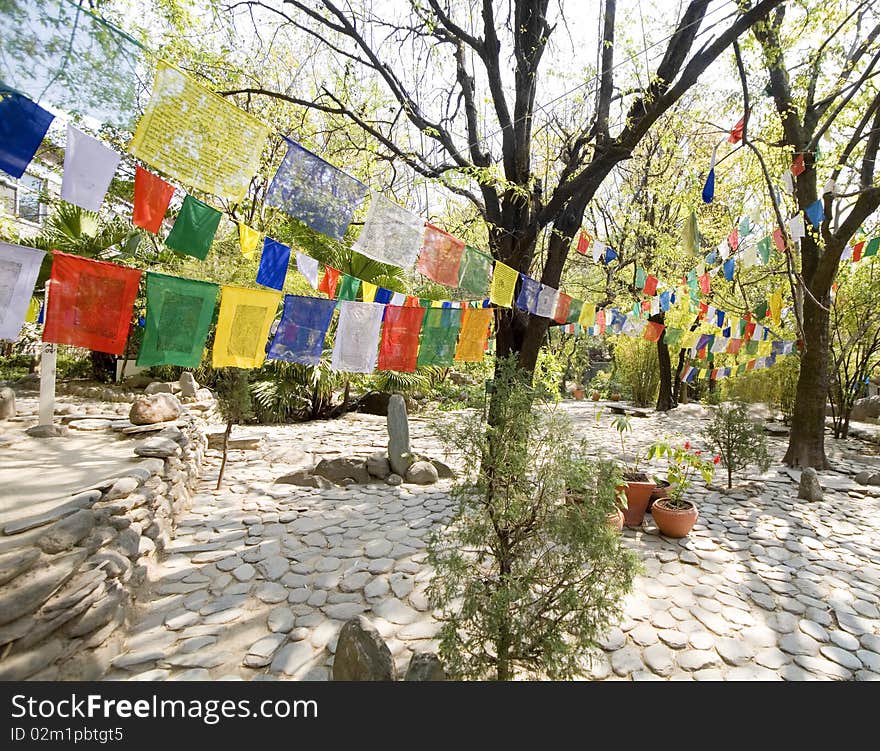 Prayer flags in a beautiful temple garden in india