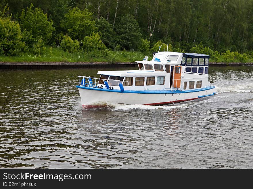 Motor ship floats on the river