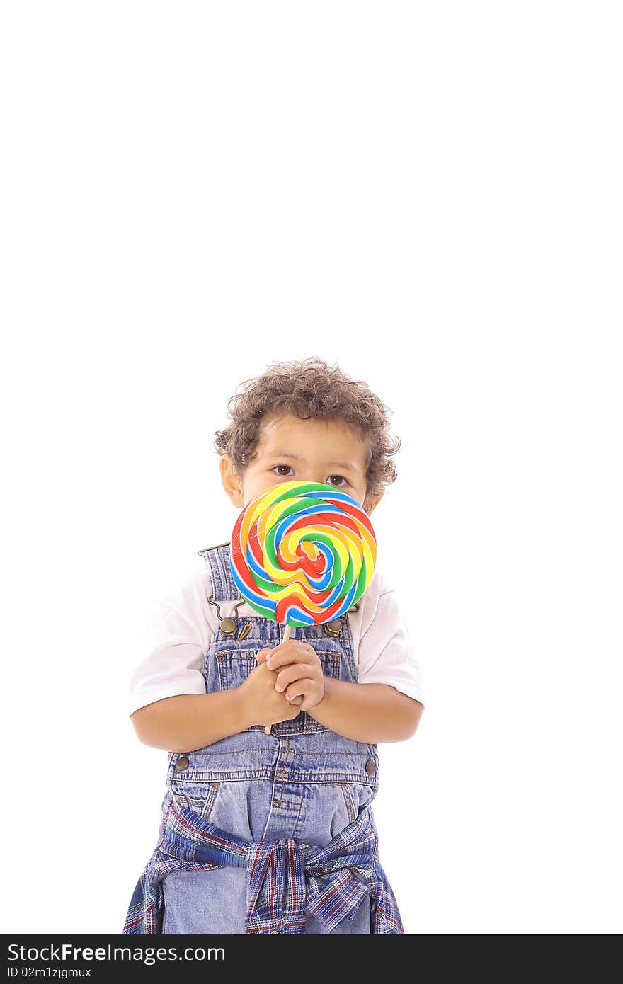 Shot of a toddler peeking behind lollipop