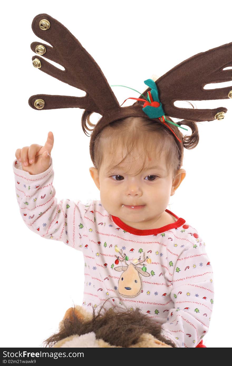 Shot of a baby on pony with reindeer ears