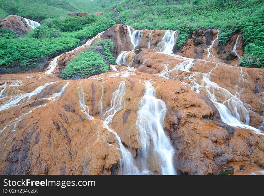 It is a waterfall on red soil, called gold fall