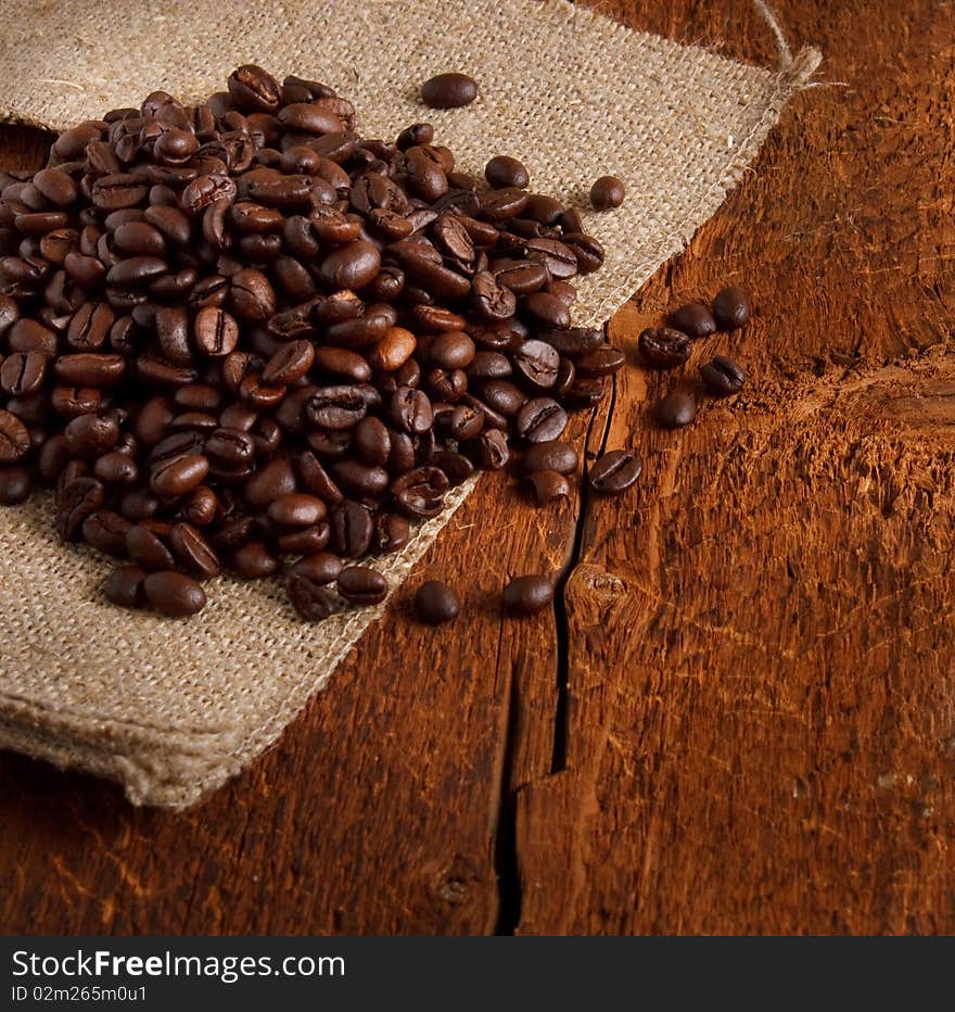 Coffe beans on wood background. Coffe beans on wood background