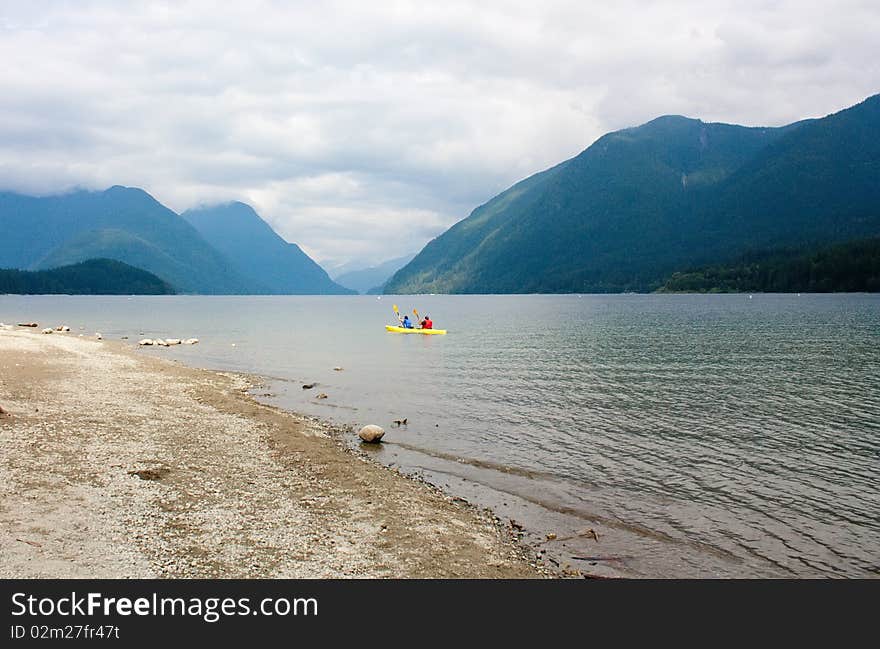 Lake between mountains at cloudy day.