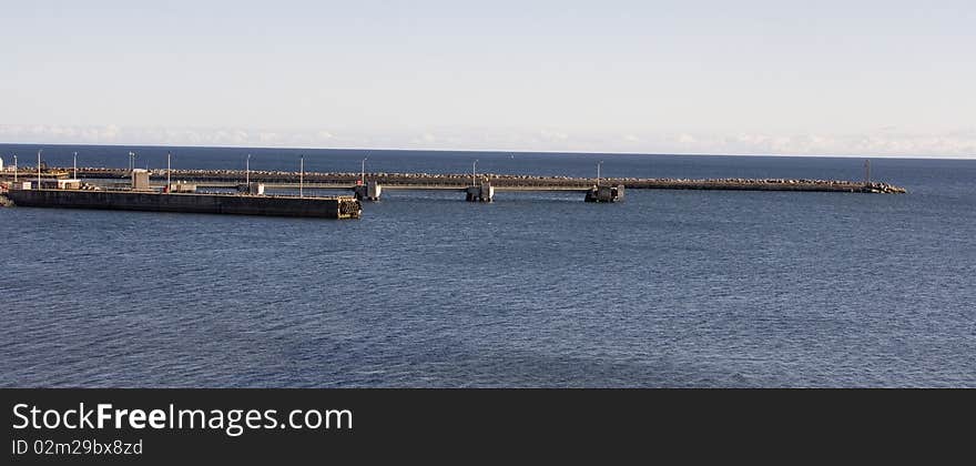 The docks of the harbor go out in the Atlantic