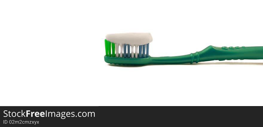 Tooth-brush with paste on a white background.