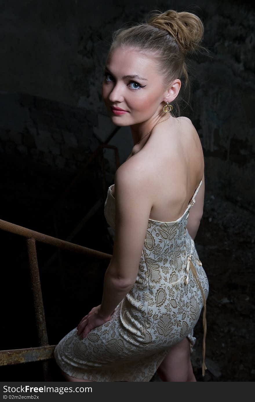 Beautiful chick standing on the grungy stairs. Beautiful chick standing on the grungy stairs