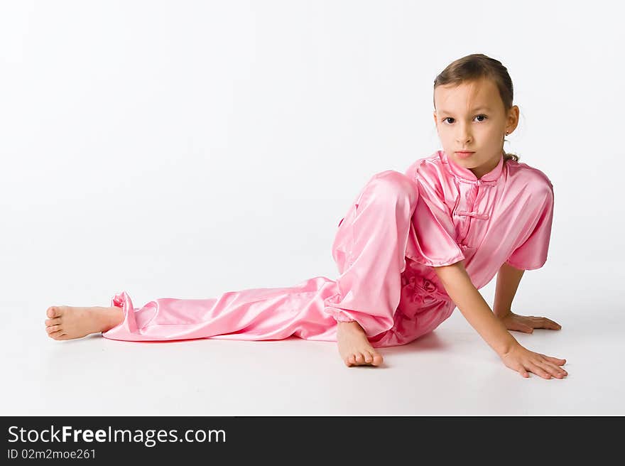 Girl in a pink kimono sitting on the floor