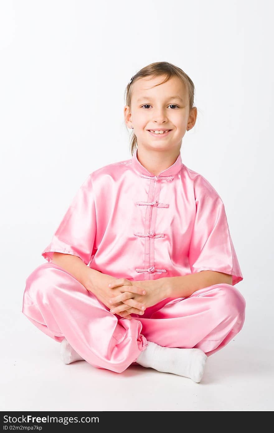 Girl in a pink kimono sitting on the floor