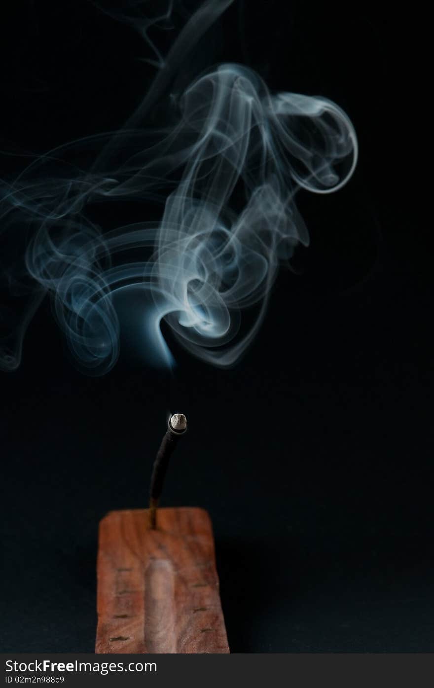 Burning incense stick in holder. Burning incense stick in holder