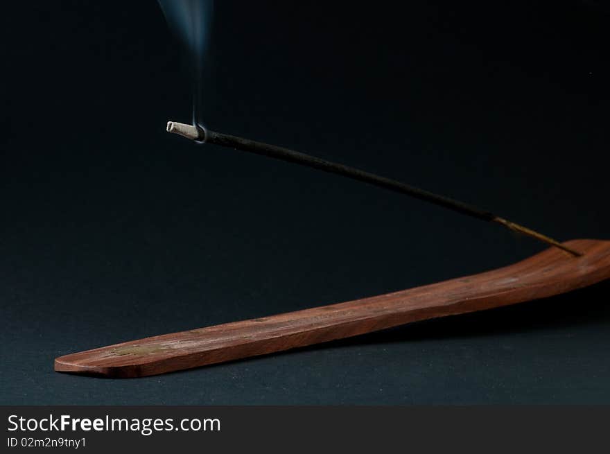 Burning incense stick in holder. Burning incense stick in holder