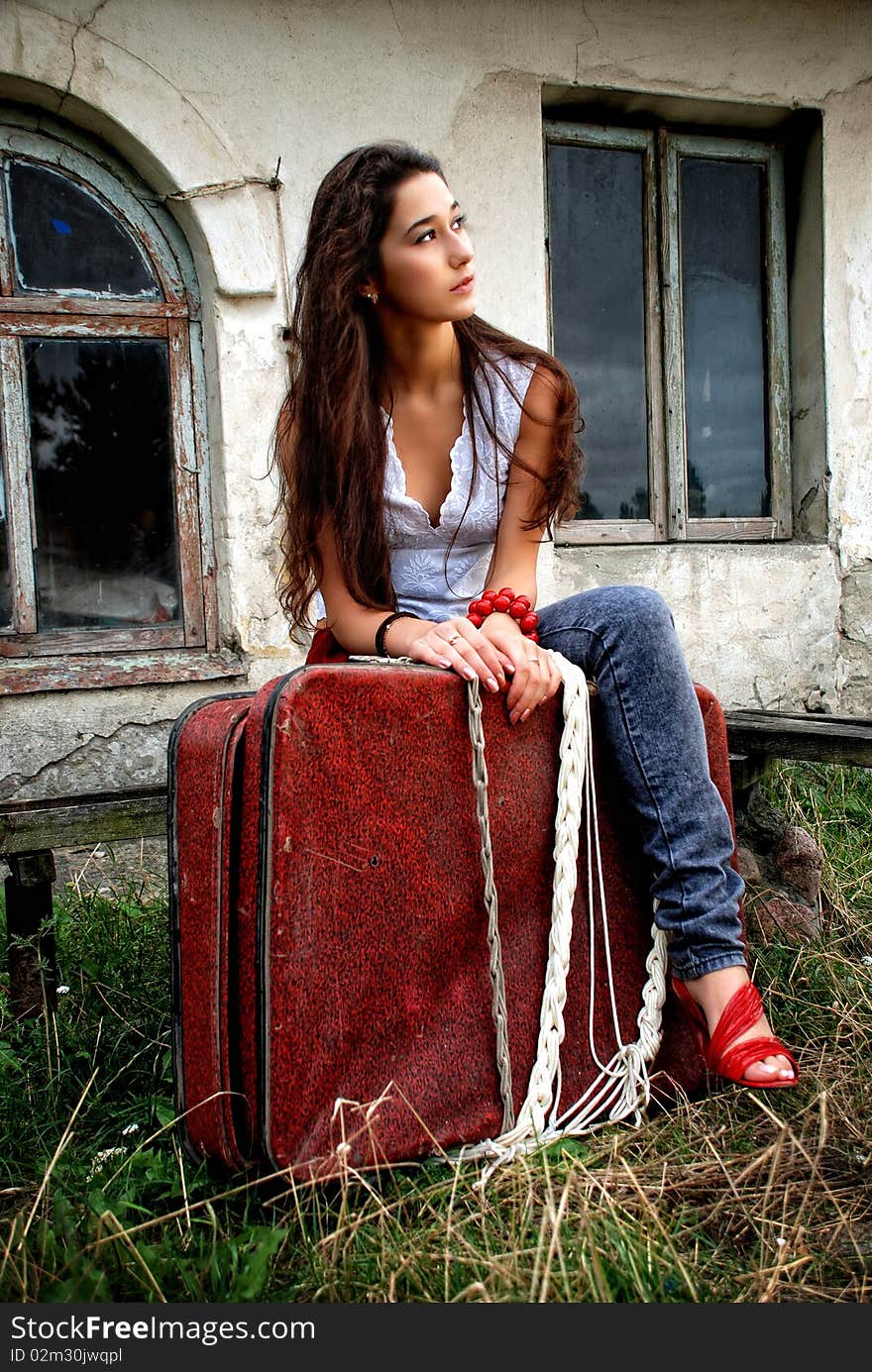 Beautiful girl with red suitcase.