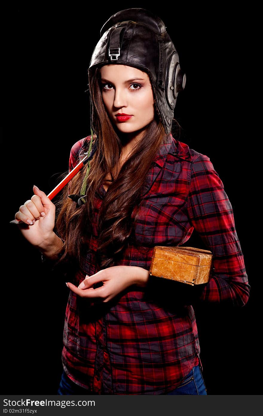 Young beautiful woman in cell shirt with red crowbar. Young beautiful woman in cell shirt with red crowbar