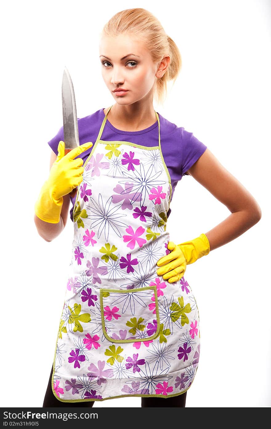 Young beautiful housewife in rubber yellow gloves with knife. Young beautiful housewife in rubber yellow gloves with knife