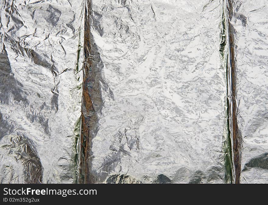 Aluminium foil reflecting background.