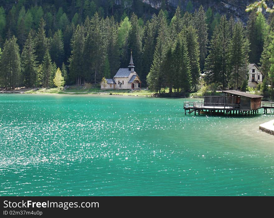 Braies lake in northern italy: church and pier. Braies lake in northern italy: church and pier