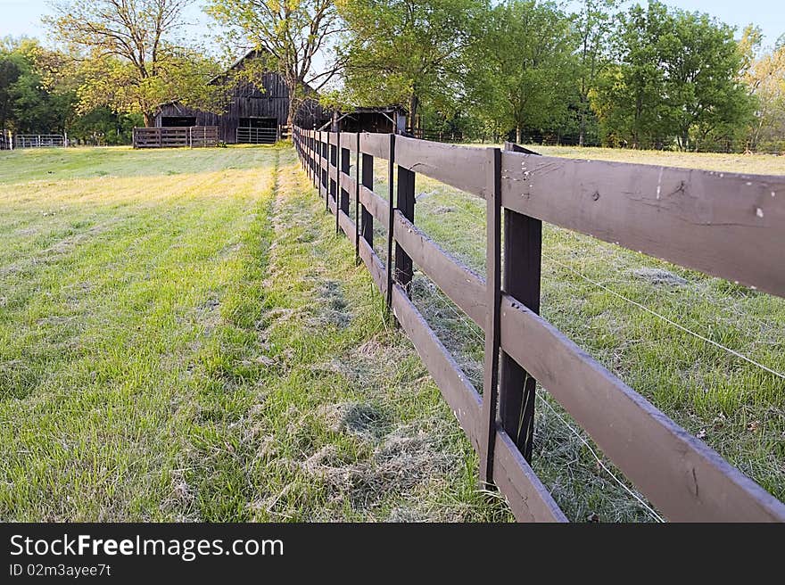 fence leading to a barn