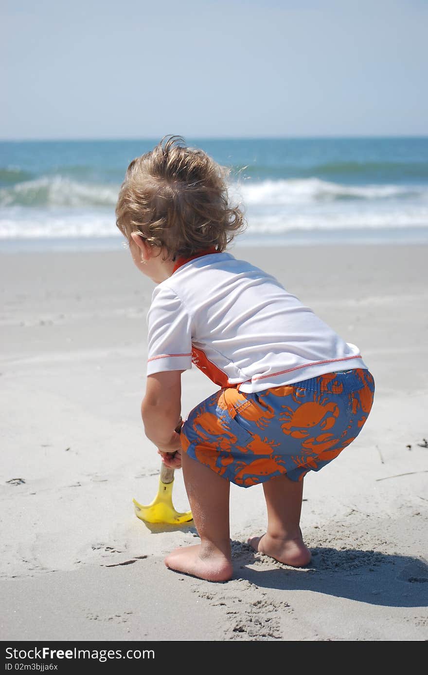 Toddler boy playing in the sand