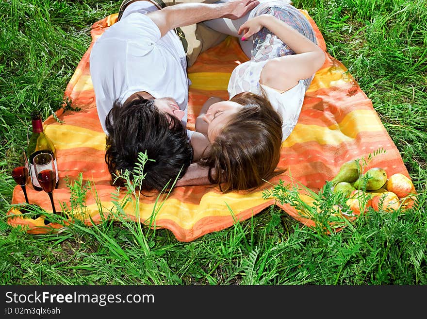 Boy and girl are sleeping on grass