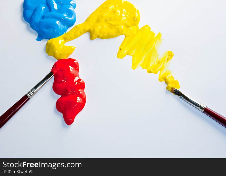 Paintbrushes and red, yellow and blue colors on a white background. Paintbrushes and red, yellow and blue colors on a white background