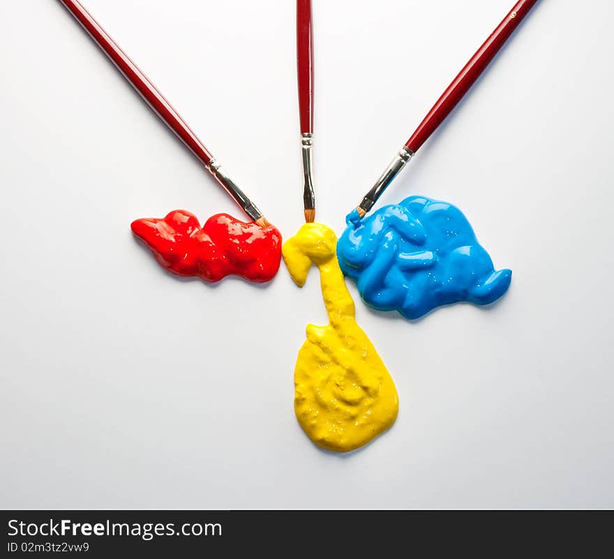 Paintbrushes and red, yellow and blue colors on a white background. Paintbrushes and red, yellow and blue colors on a white background