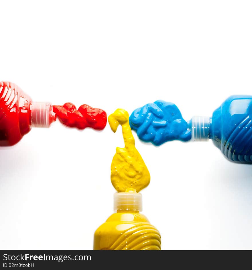 Bottles of red, yellow and blue colors on a white background