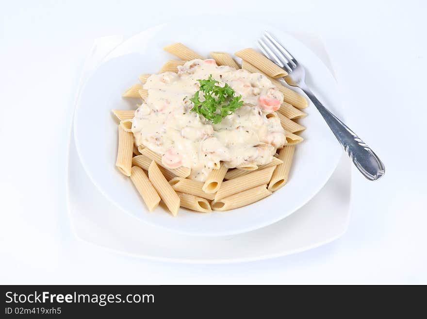 Penne with white sauce on a plate decorated with parsley