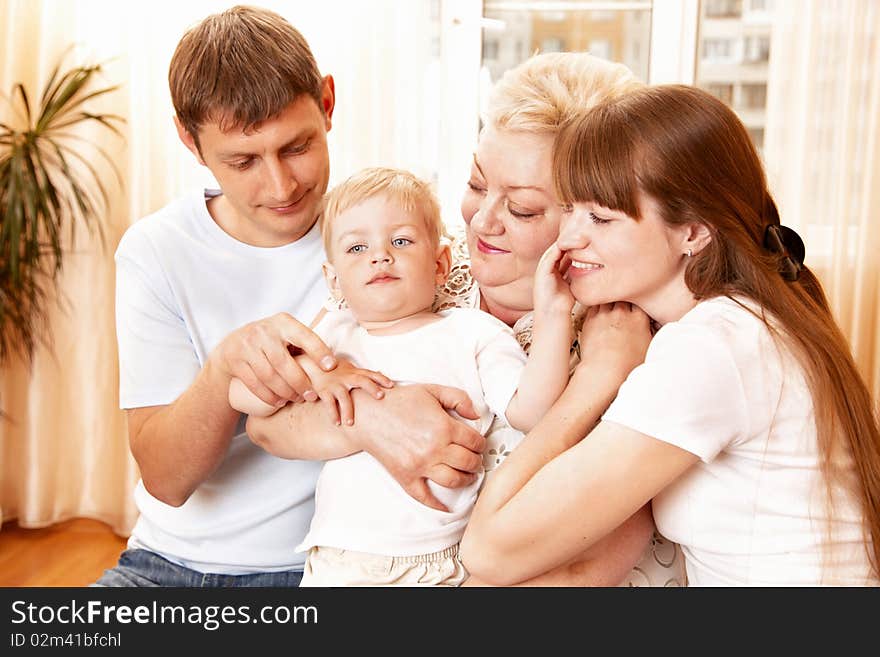 Mother, father and grandmother playing with child indoor. Mother, father and grandmother playing with child indoor