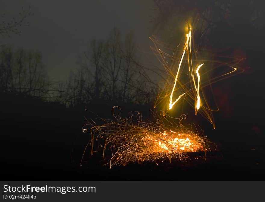 Star painting by fire in the dark. Star painting by fire in the dark