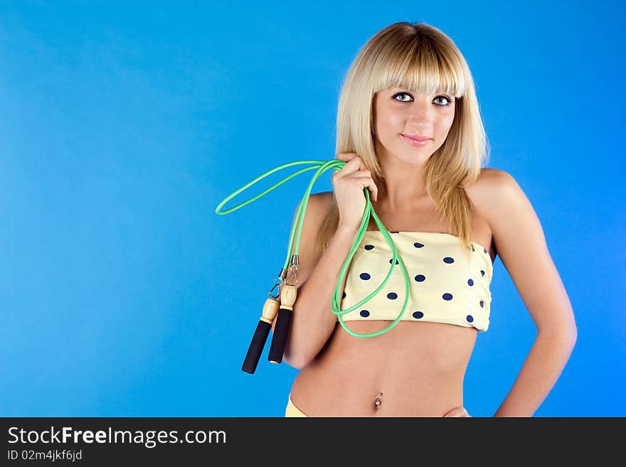 Woman On Blue Holding A Jump Rope