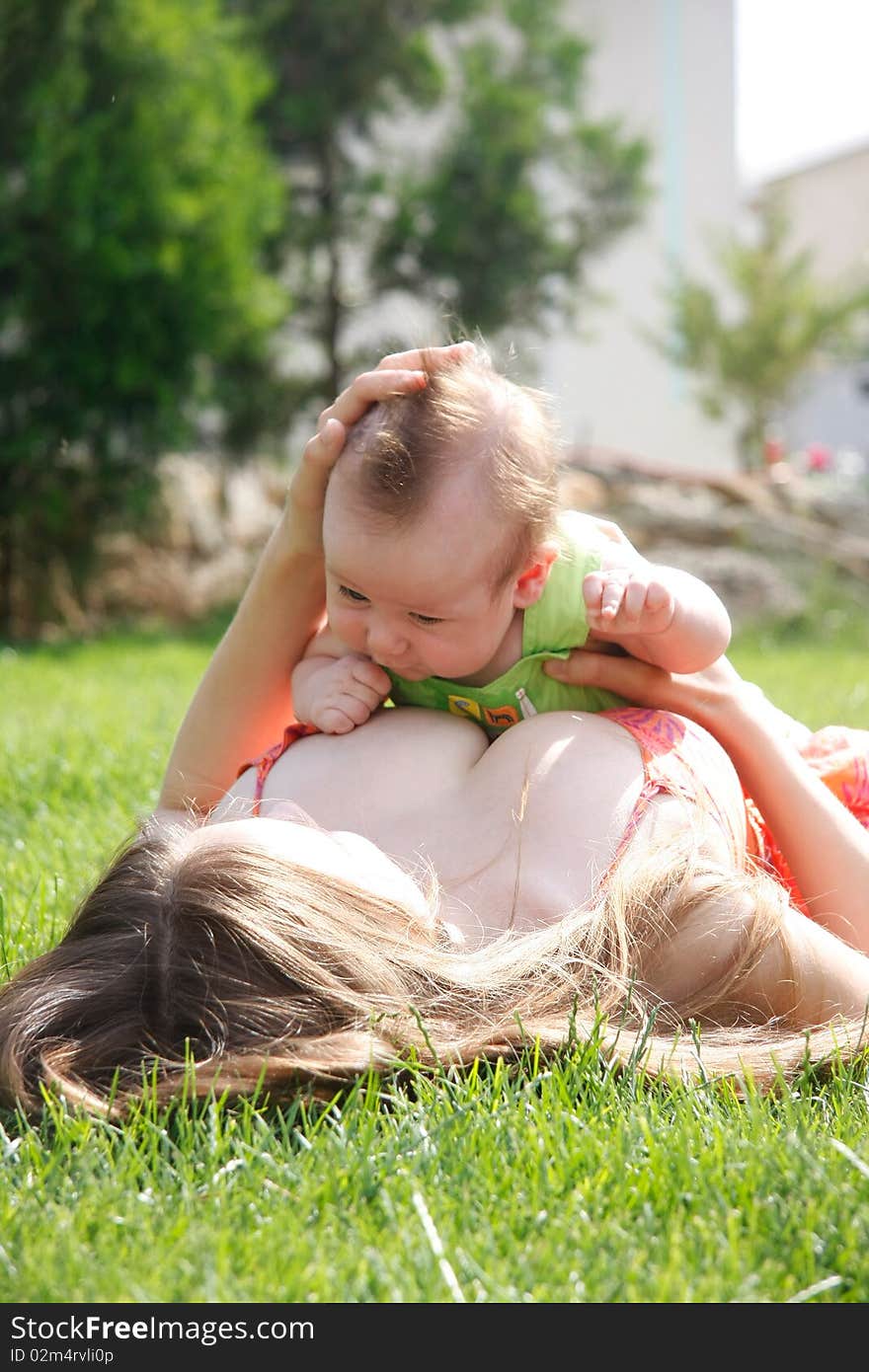 Mother And Baby On Natural Background