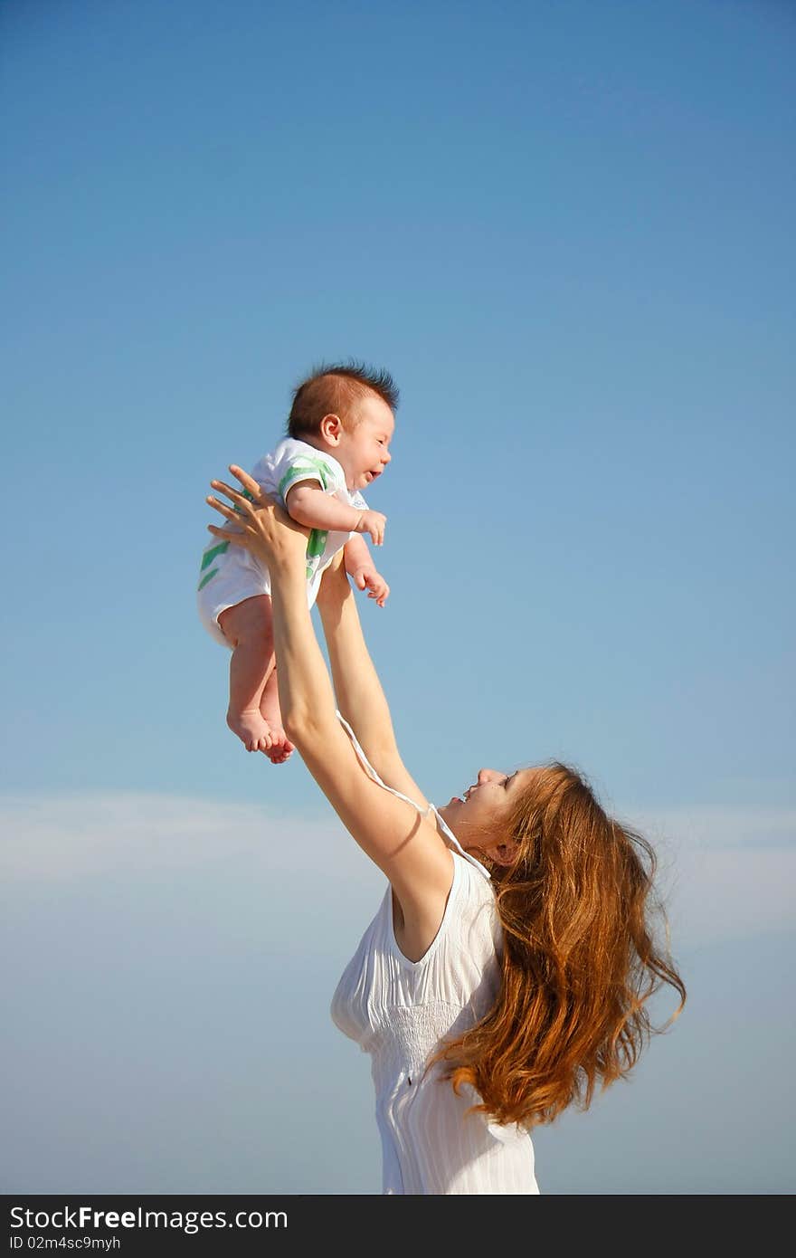 Happy mothar and baby on sky background