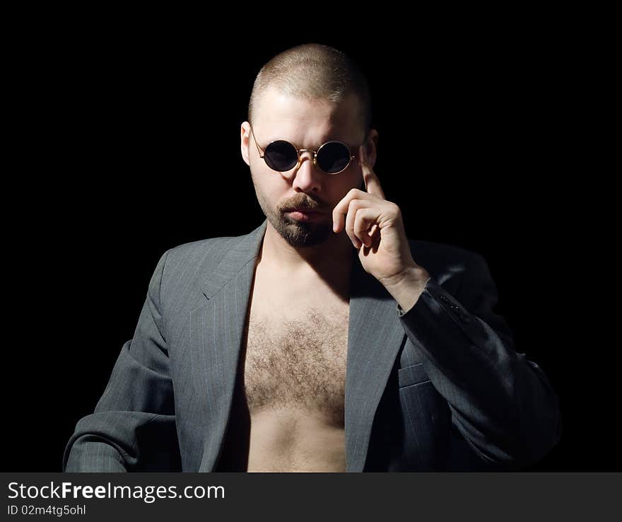 Portrait of bristly man in coat in the dark