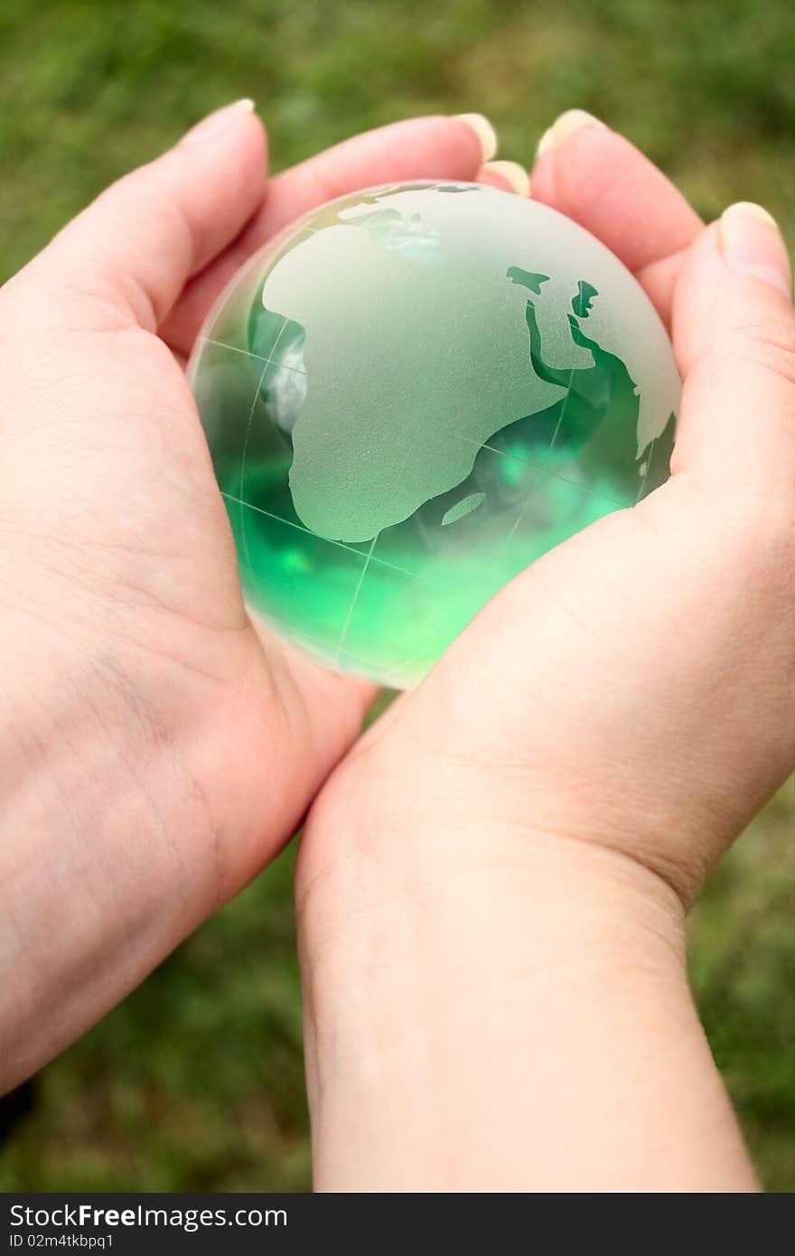 Glass ball in the hands of the planet