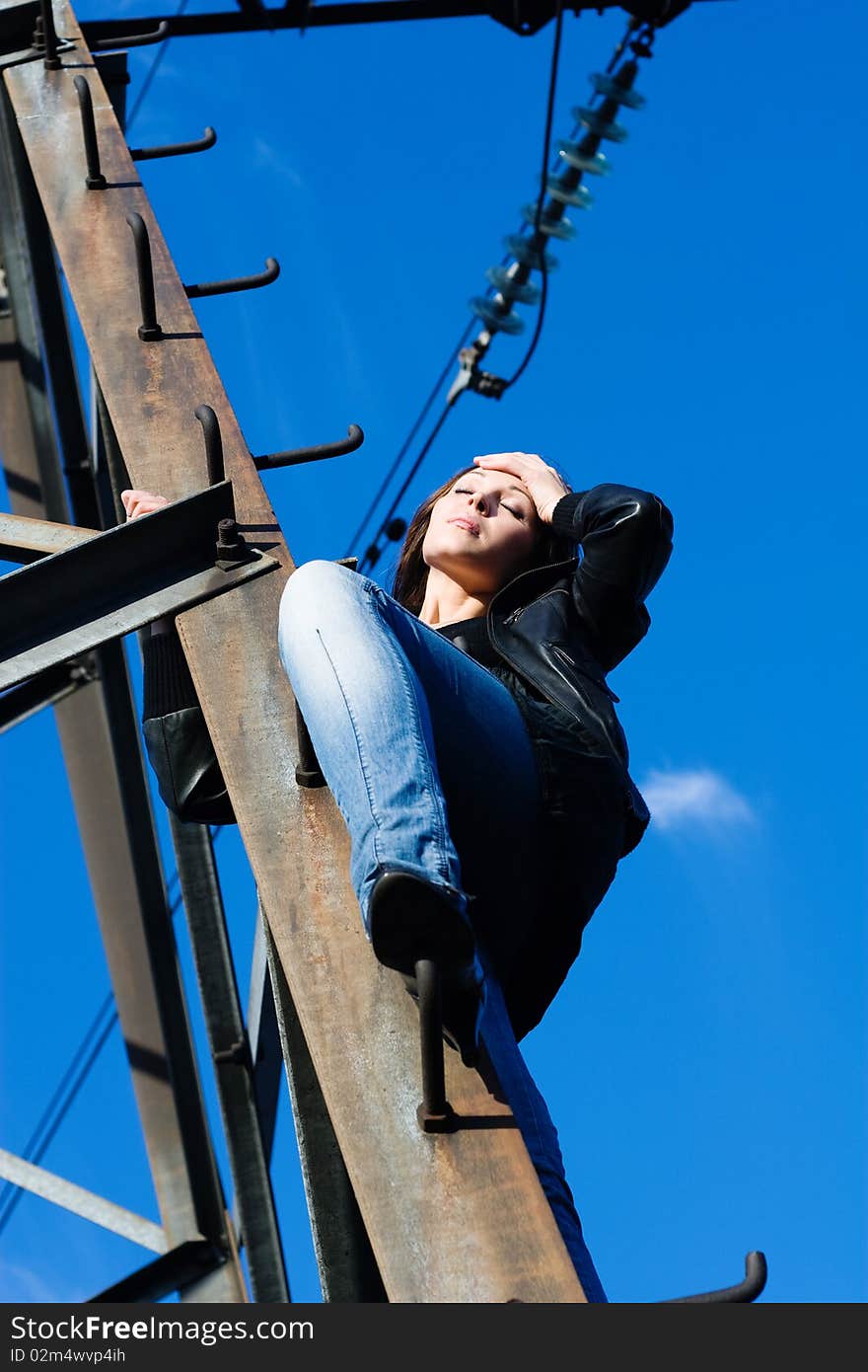 Woman on electrical tower