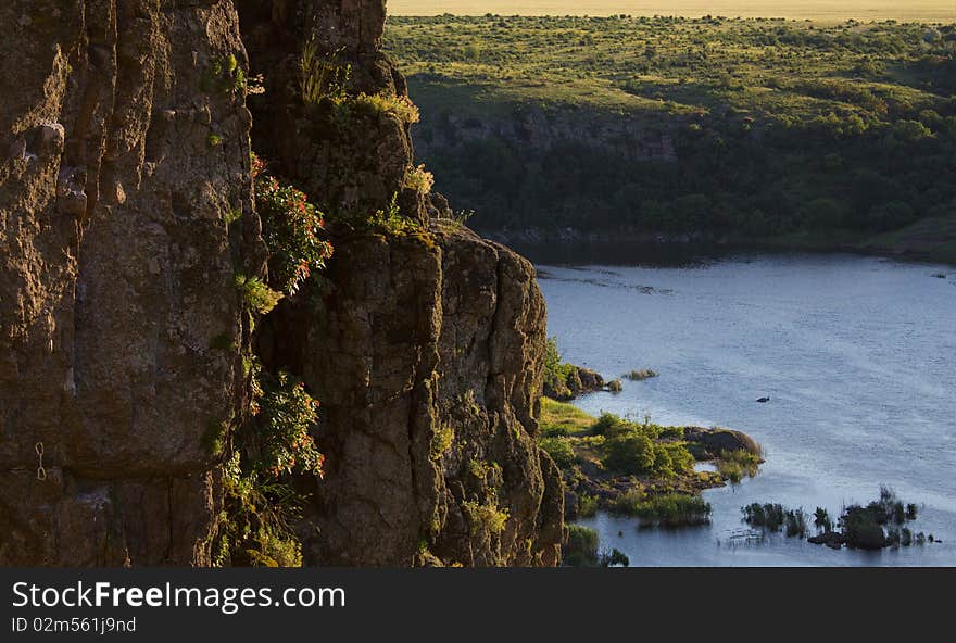 Climbing route above the river in the evening. Climbing route above the river in the evening