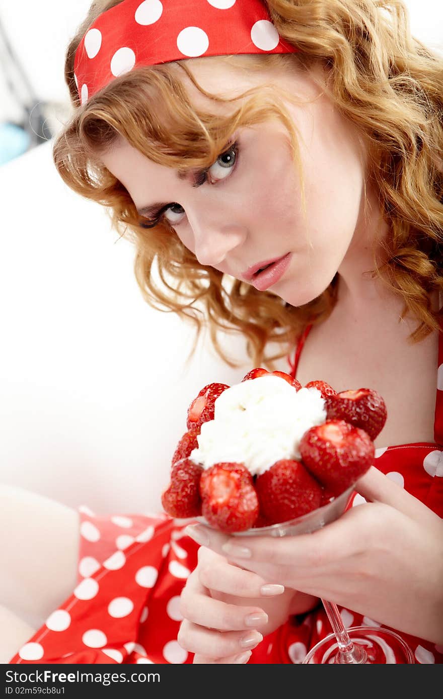 Young beautiful girl eating strawberries. Young beautiful girl eating strawberries