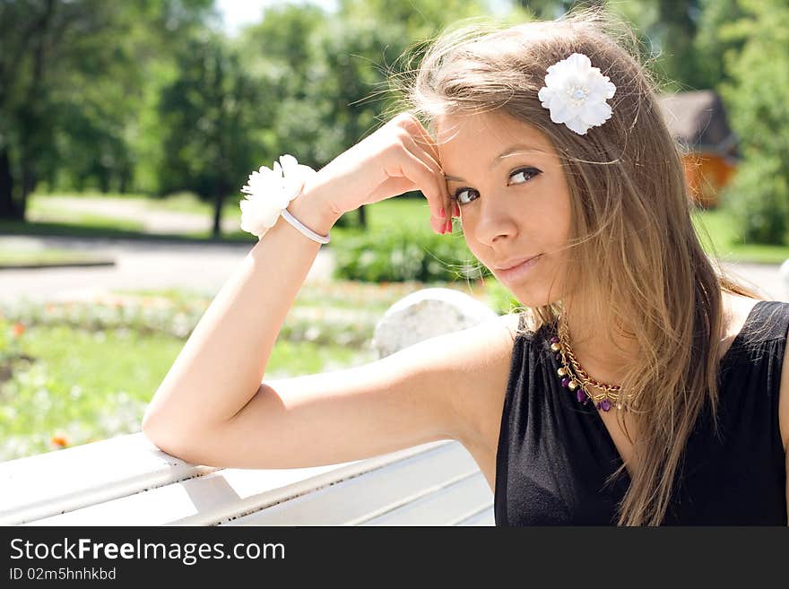 Girl sitting on bench outdoor