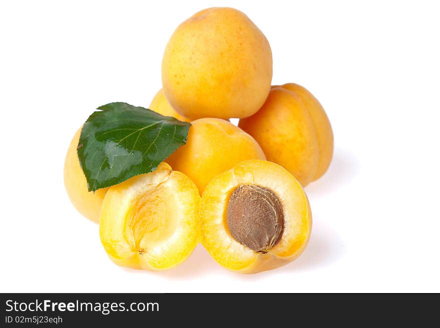 Ripe juicy apricots on white background