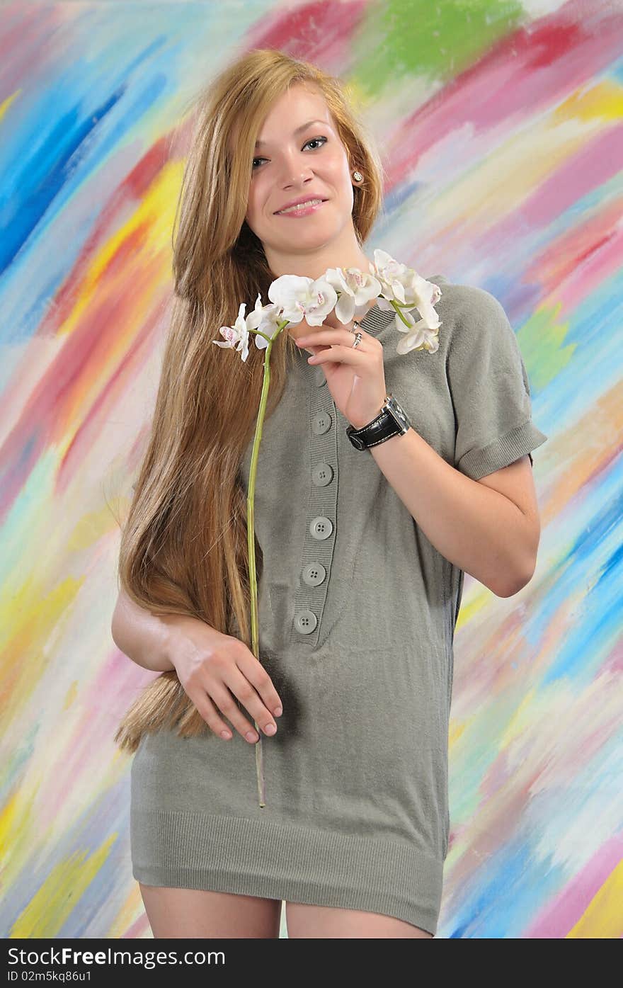 Portrait of long-haired beautiful girl 16-17 years with orchid. Portrait of long-haired beautiful girl 16-17 years with orchid