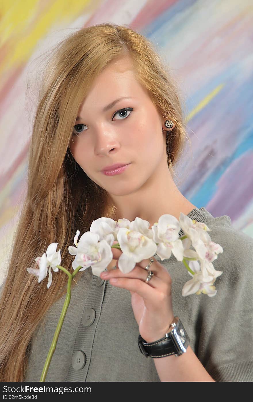 Portrait of long-haired beautiful girl 16-17 years with orchid. Portrait of long-haired beautiful girl 16-17 years with orchid