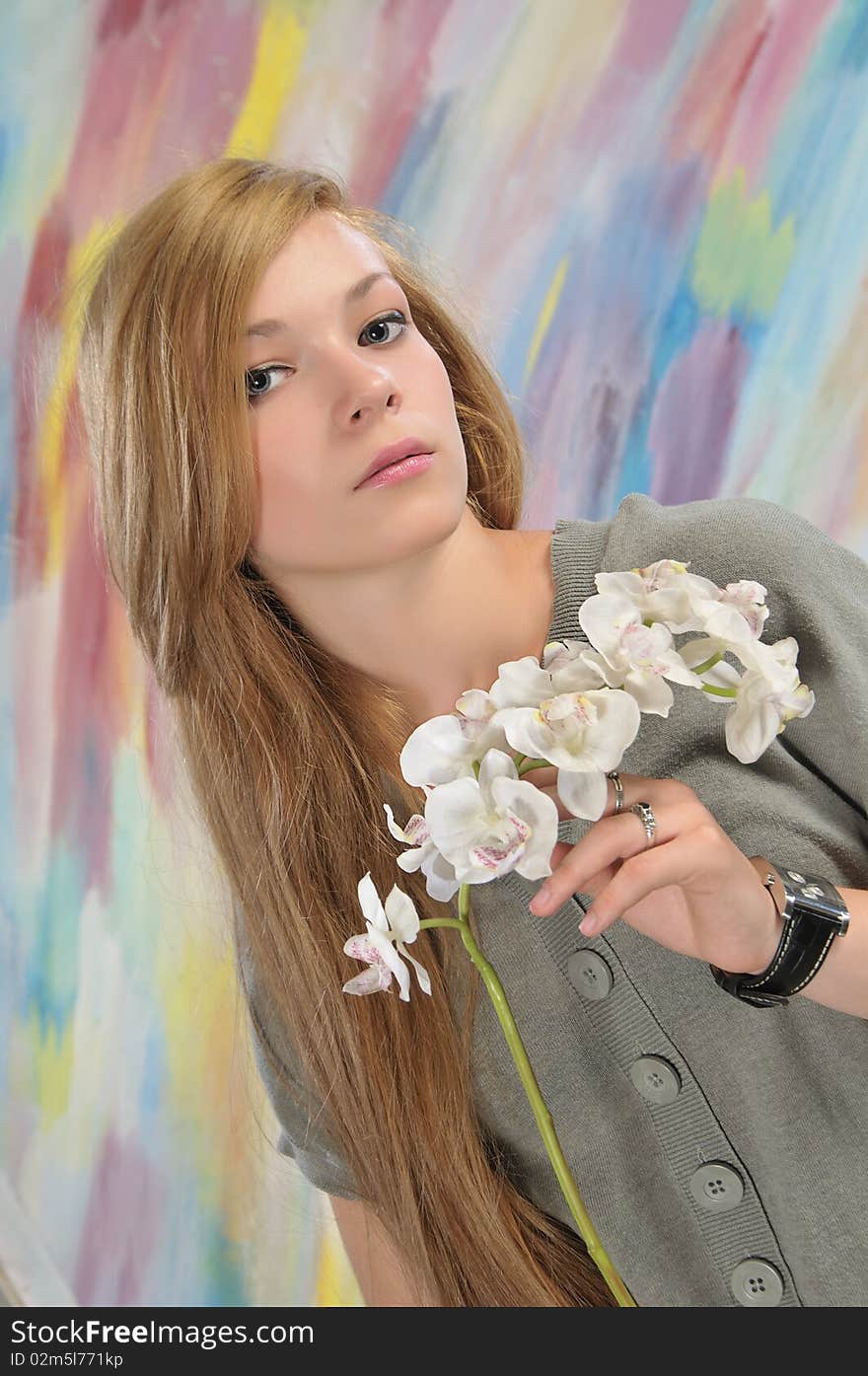 Portrait of long-haired beautiful girl 16-17 years with orchid. Portrait of long-haired beautiful girl 16-17 years with orchid