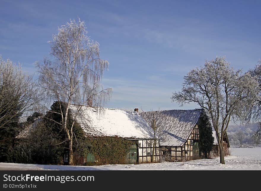 Farm in winter in Hilter-Hankenberge, Osnabruecker land, Lower Saxony, Germany. Farm in winter in Hilter-Hankenberge, Osnabruecker land, Lower Saxony, Germany